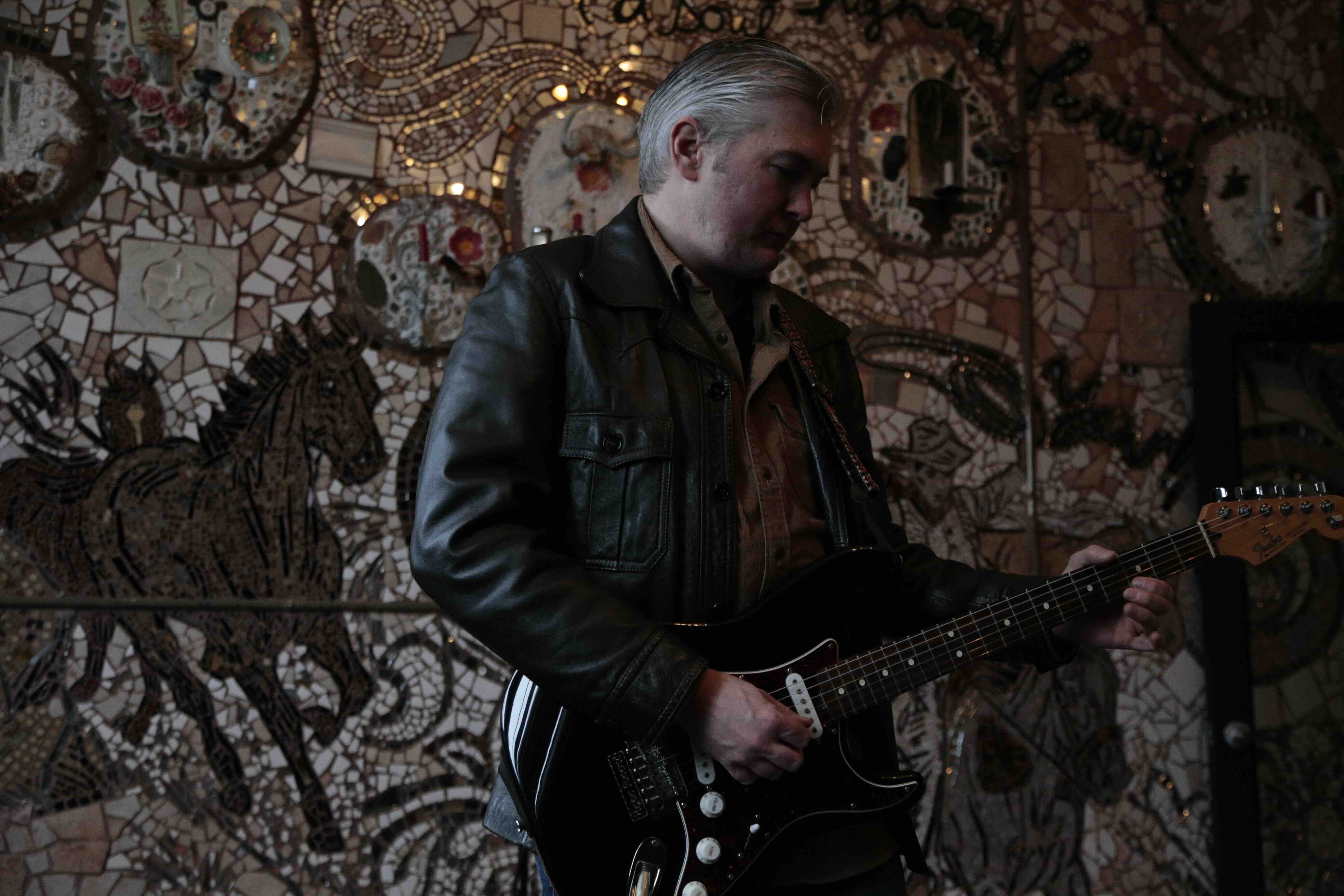 Austin recording in front of a super cool mosaic wall